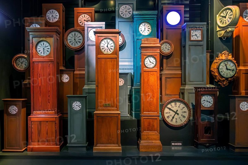 Collection of antique wooden railway station clocks at Train World, railway museum in Schaerbeek, Schaarbeek, Brussels, Belgium