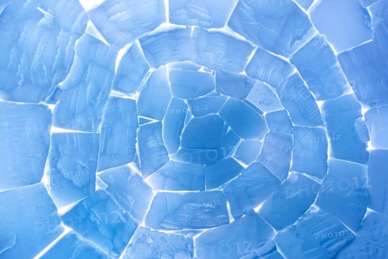 Interior of igloo showing roof built from stacked snow bricks in a catenary, curved shape resembling a paraboloid on Svalbard, Spitsbergen, Norway