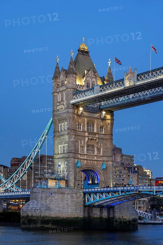 19th century Tower Bridge, neo-Gothic bascule / suspension bridge crossing the River Thames in the capital city London at dusk, England, UK