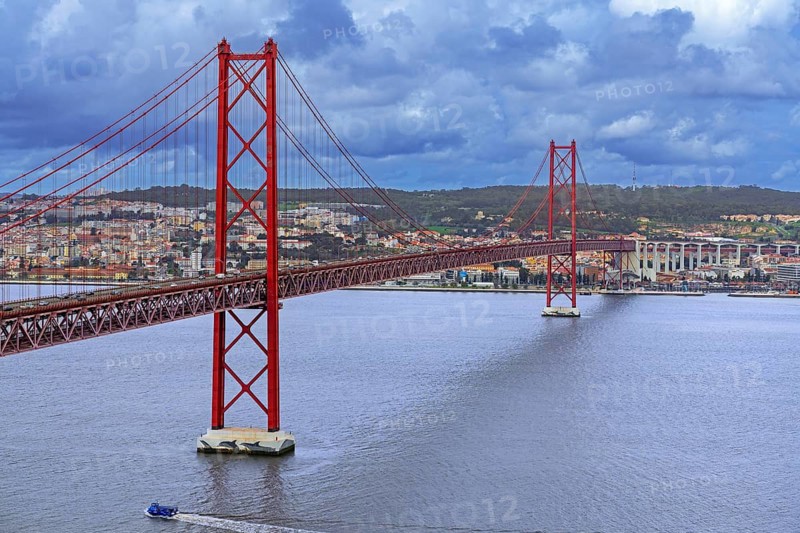 Ponte 25 de Abril / 25th of April Bridge, red suspension bridge over the Tagus River connecting the city of Lisbon / Lisboa to Almada, Portugal