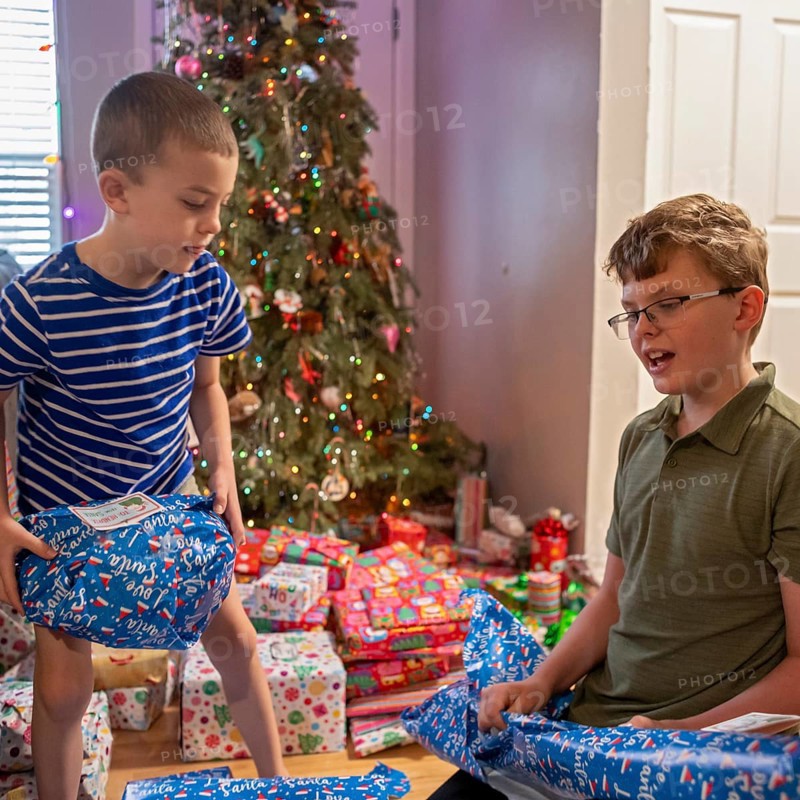 Denver, Colorado - Brothers open Christmas presents on Christmas morning