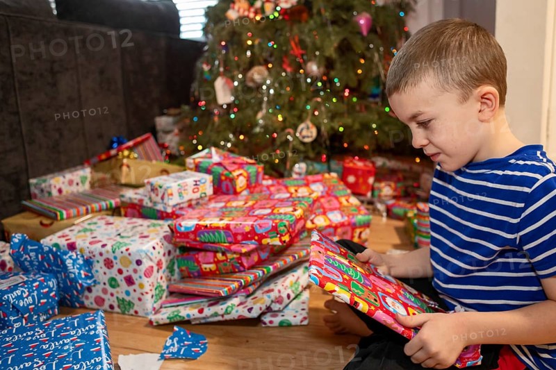 Denver, Colorado - A boy opens Christmas presents on Christmas morning