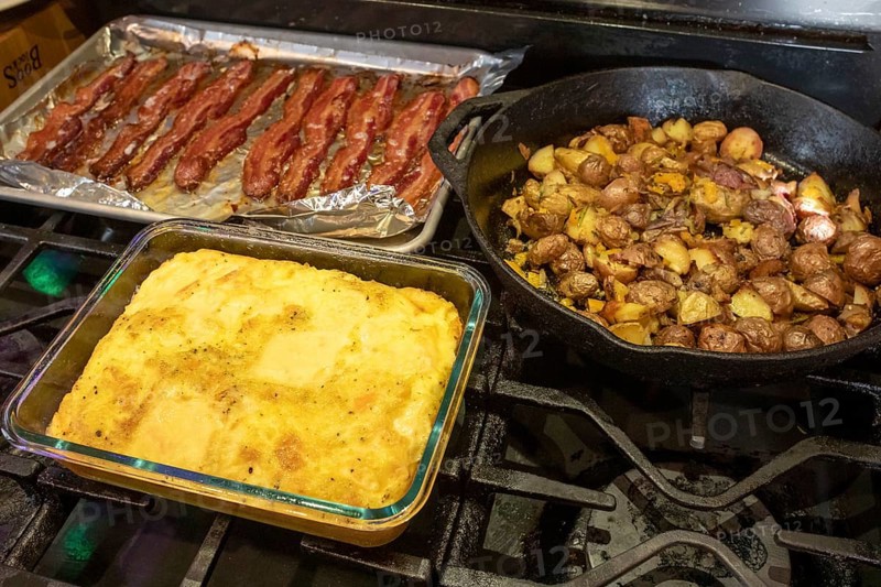 Denver, Colorado - Eggs, potatoes, and bacon on the stove for breakfast
