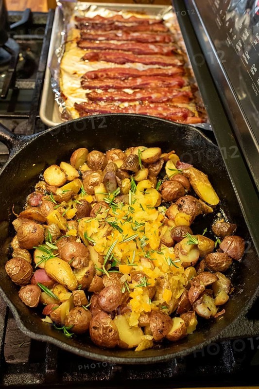 Denver, Colorado - Potatoes and bacon cookingon the stove for breakfast
