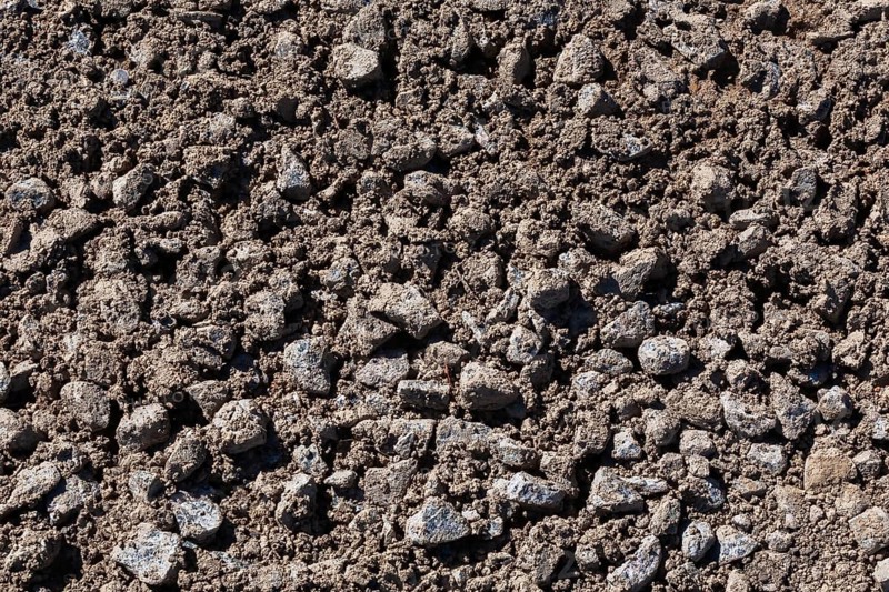 Close-up of sand mixed with grey crushed stone aggregate used to form a bed for constructing roads and driveways on, Quebec, Canada