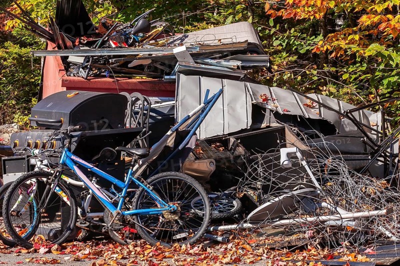 Pile of discarded metal objects including bicycles, sheet metal cladding, pipes, steel wire waiting for transport to recycling yard, Quebec, Canada