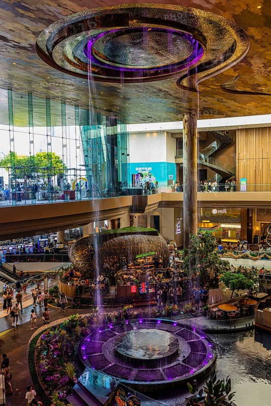 Artificial, brightly lit waterfall, magic waterfall, plunging from ceiling into a water basin, Iconsiam shopping center, Bangkok, Thailand's metropolis