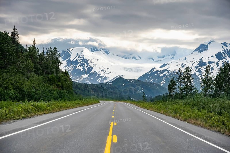 Road through mountain landscape, picturesque landscape with Worthington glacier, dramatic cloudy sky, Richardson Highway, Alaska, USA