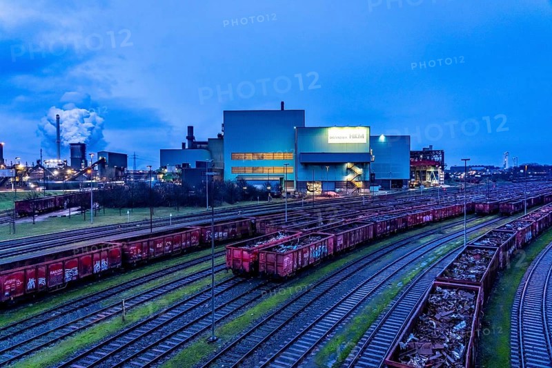 Hüttenwerke Krupp-Mannesmann, HKM in Duisburg, houses of the blast steel plant, coking plant, extinguishing tower with fire cloud, marshalling yard tracks, freight wagon with scrap metal, for melting down, North Rhine-Westphalia, Germany