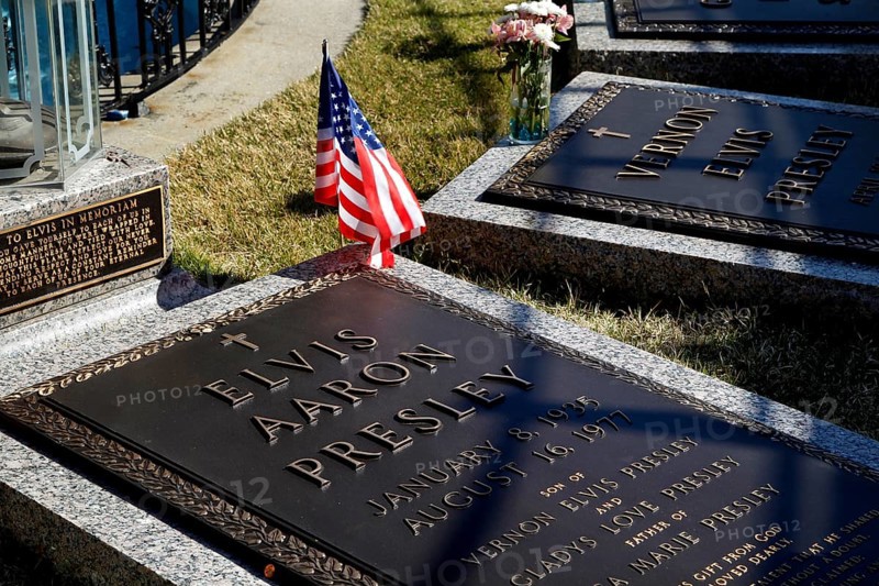 Engraved grave slabs of Elvis Presley with an American flag, Memphis, Tennessee, USA