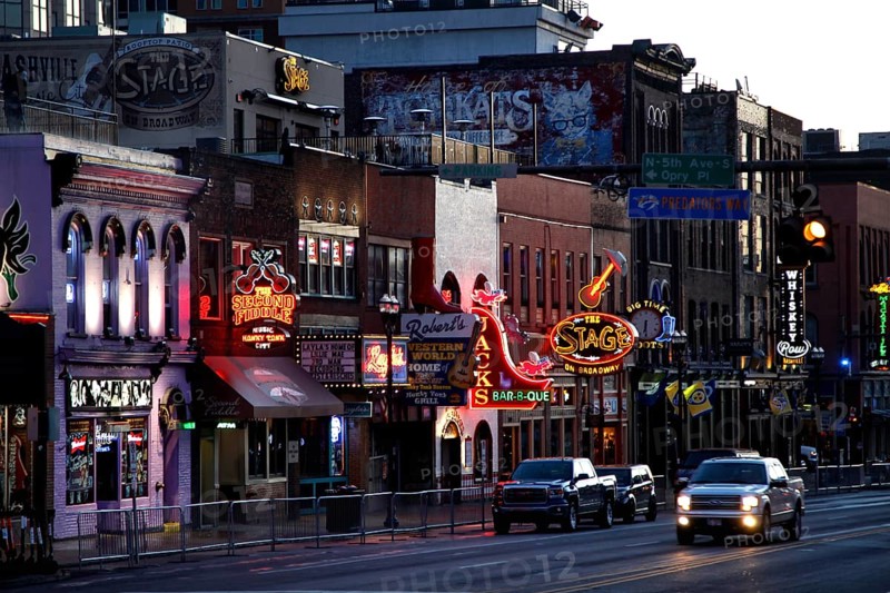 Broadway street lights at night with cars passing by, Nashville, Tennessee, USA
