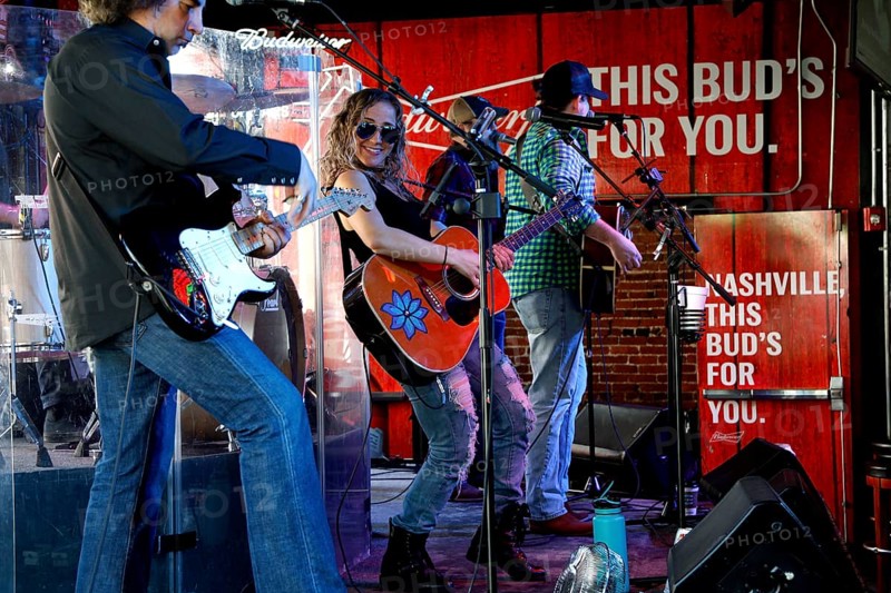Band plays energetic music in front of a banner with the inscription 'This Bud's for You, 'Nashville, Tennessee, USA