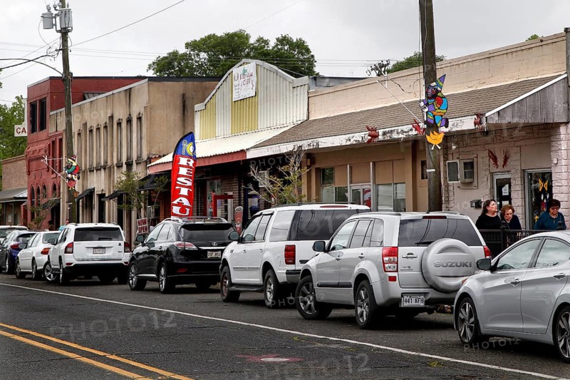 Bustling main street in Mamou with parked cars and buildings, Mamou, Louisiana, USA