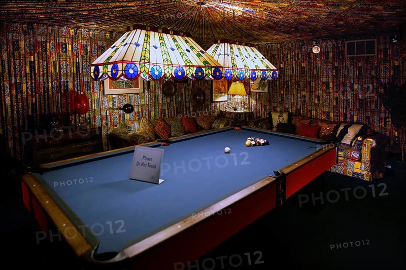 Billiard room with blue table and bright strip lights, cozy atmosphere in Graceland, Memphis, Tennessee, USA