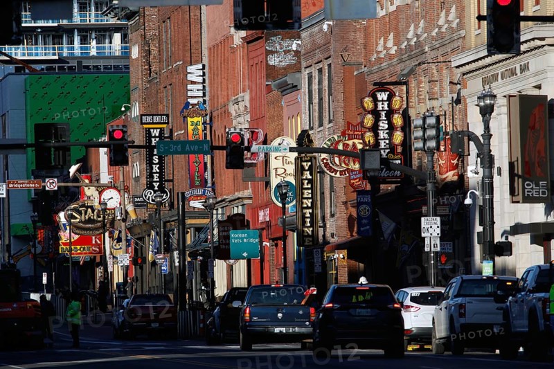 Cars drive along a busy Broadway street, Nashville, Tennessee, USA
