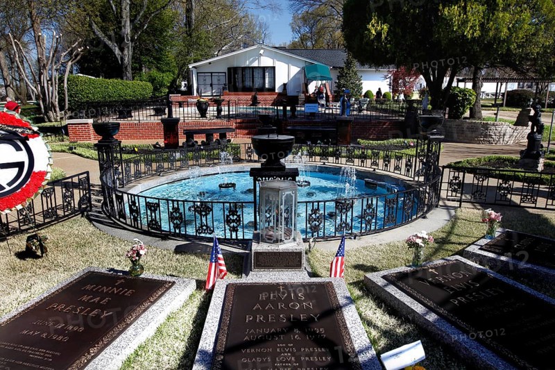 Graves with flags and a round fountain in a green setting, Memphis, Tennessee, USA
