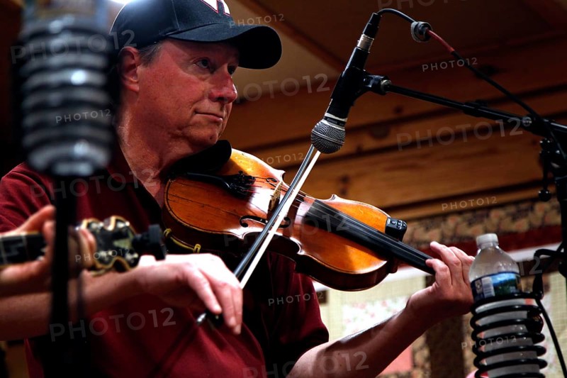 A musician with a violin during a performance at Floyd Country Store, Floyd, Virginia, USA