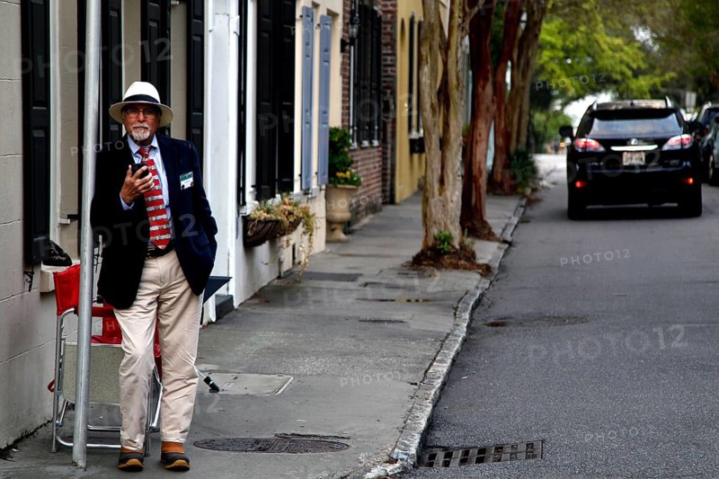 A walker on a street with historic antebellum houses, Charleston, South Carolina, USA