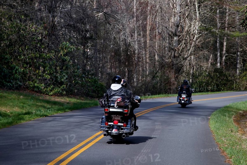 Motorcyclists ride on a winding road through wooded area, Blue Ridge Parkway, USA