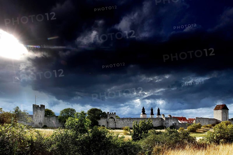Visby city wall and cathedral towers against a dramatic sky, Visby, Gotland, Sweden