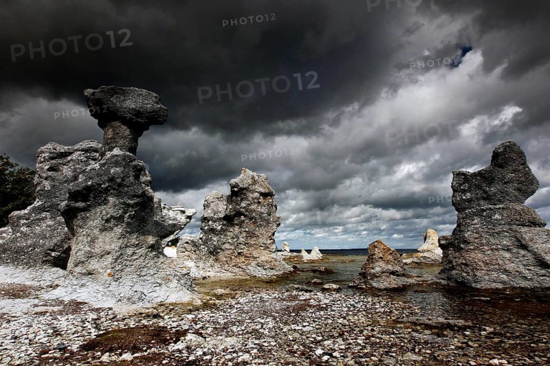 Impressive limestone pillars rise under dramatic clouds, Ljugarn, Gotland, Sweden