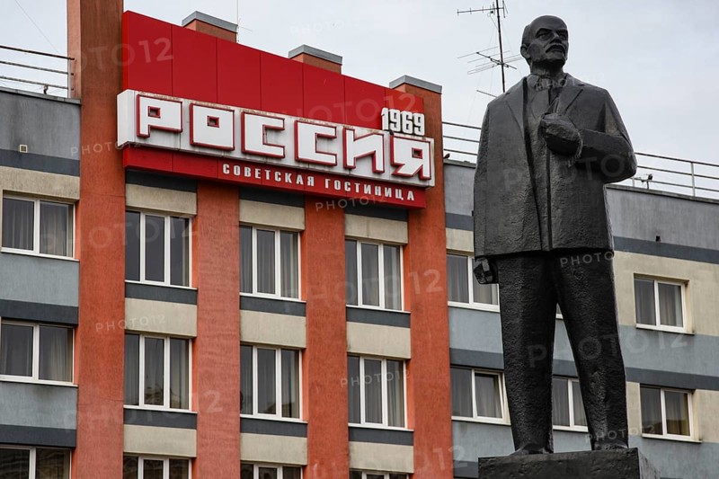 Large statue in front of a building with prominent lettering, Sovetsk, Kaliningrad, Russia