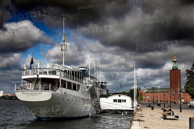 Stockholm City Hall on Kungsholmen with adjacent harbor and dramatic sky, Stockholm, Kungsholmen, Sweden