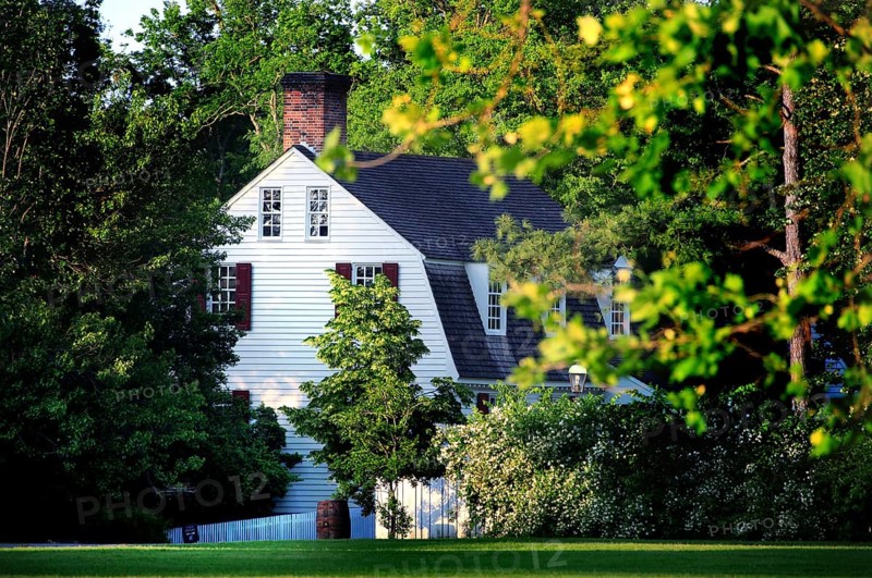 A historic building surrounded by lush trees in Colonial Williamsburg, Williamsburg, Virginia, USA