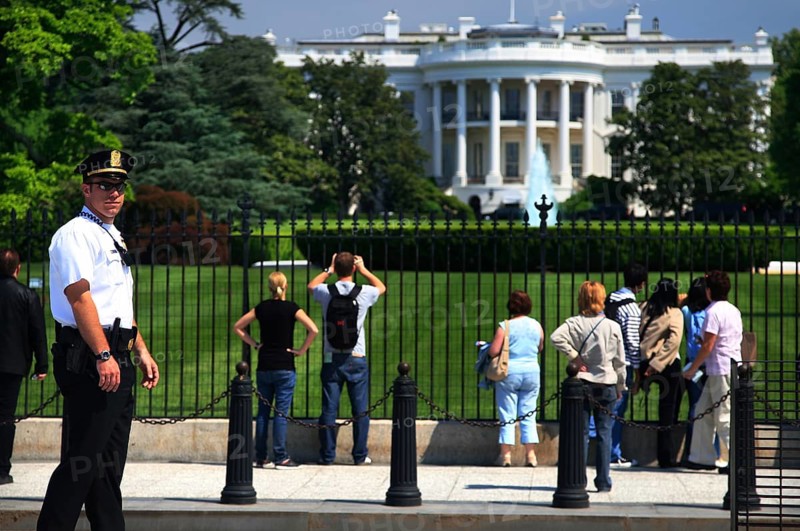 Visitors view the White House from a public area, Washington D.C, USA