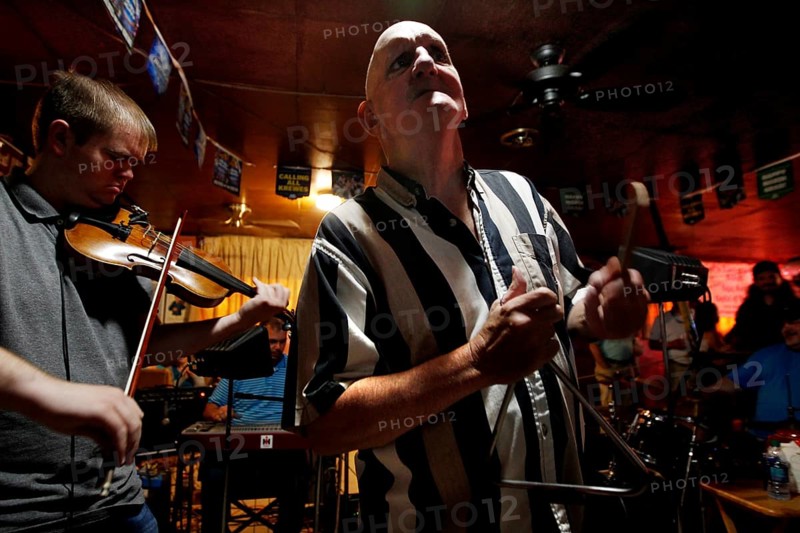 A triangle player performs with a violinist in the Cajun band, Mamou, Louisiana, USA