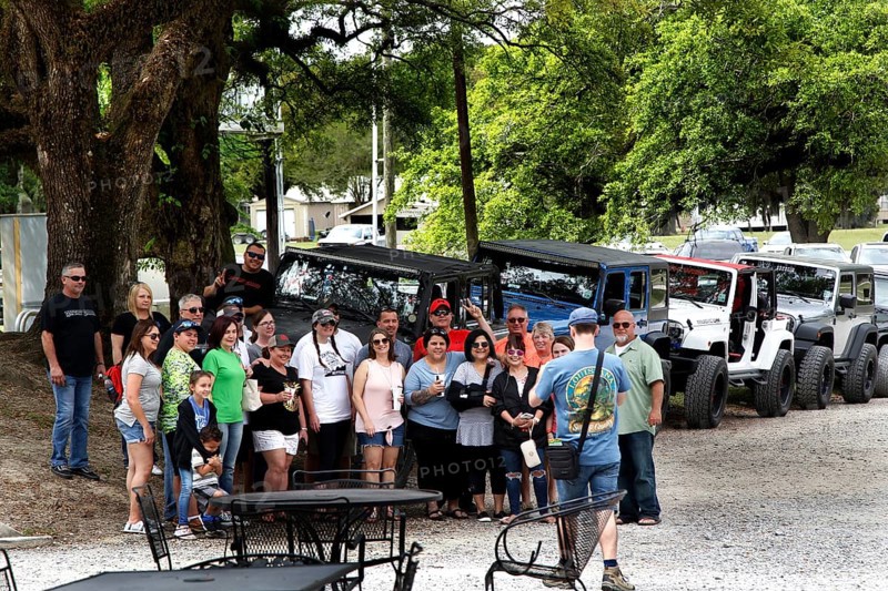 Group of visitors in front of vehicles at the McIlhenny Tabasco factory on Avery Island, Avery Island, Louisiana, USA