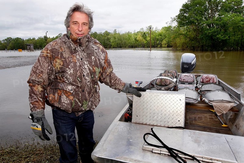 A man stands in a boat at the Atchafalaya Basin, ready for a tour in the wetlands, zero