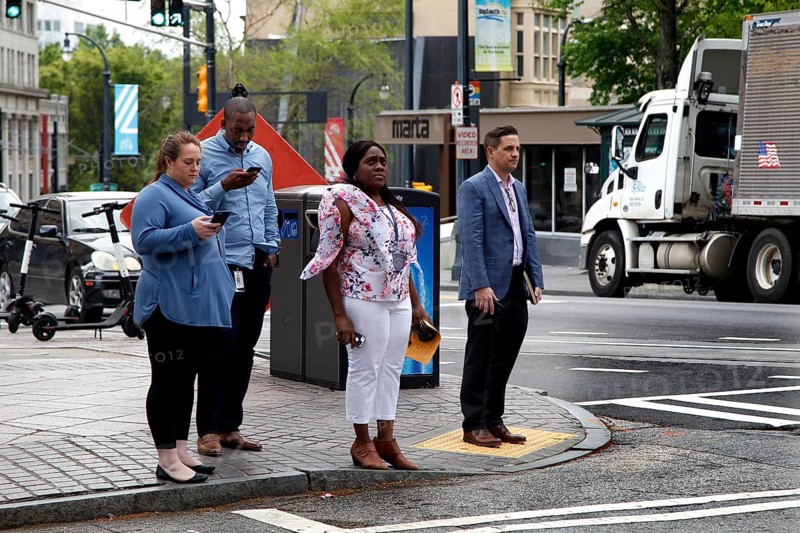 People wait at a pedestrian crossing in downtown Atlanta on Peachtree Street, Atlanta, USA