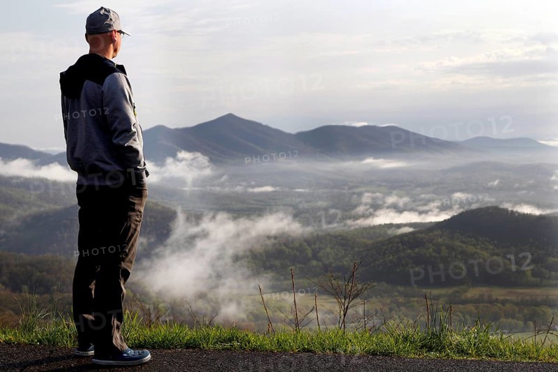 Man standing at Blue Ridge Parkway looking over misty mountain landscape, Blue Ridge Parkway, Virginia, USA