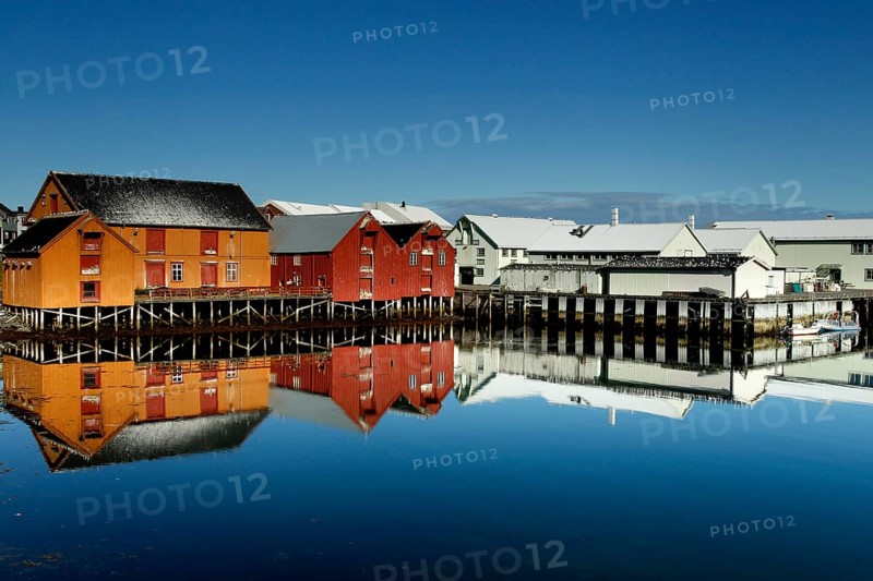 Warehouses are reflected in the calm water of the port of Vardø, Vardø, null, Norway