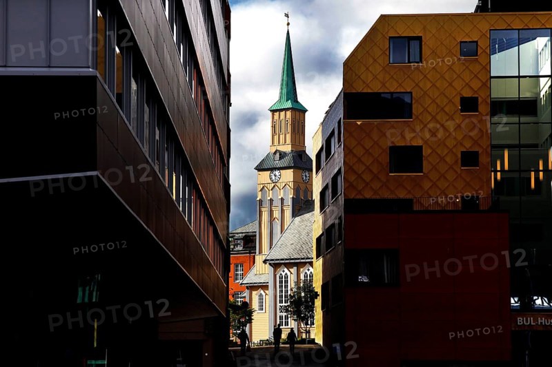 View of the cathedral between modern buildings in Tromsø, Tromsø, Troms, Norway