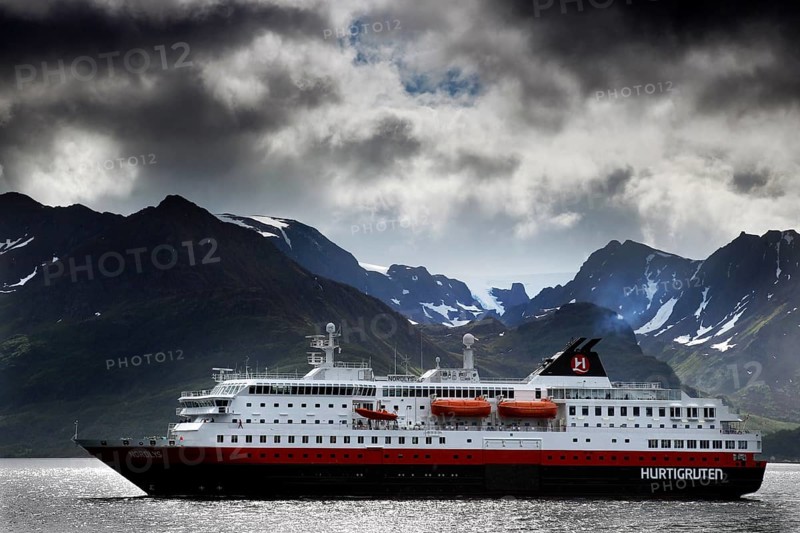 Hurtigruten ship in Øksfjord in front of a majestic mountain panorama, Øksfjord, Norway
