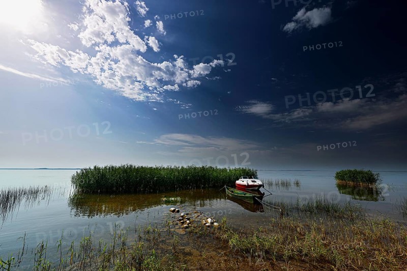 Sunset on the Curonian Spit in Vente with calm water and clouds, Vente, Lithuania