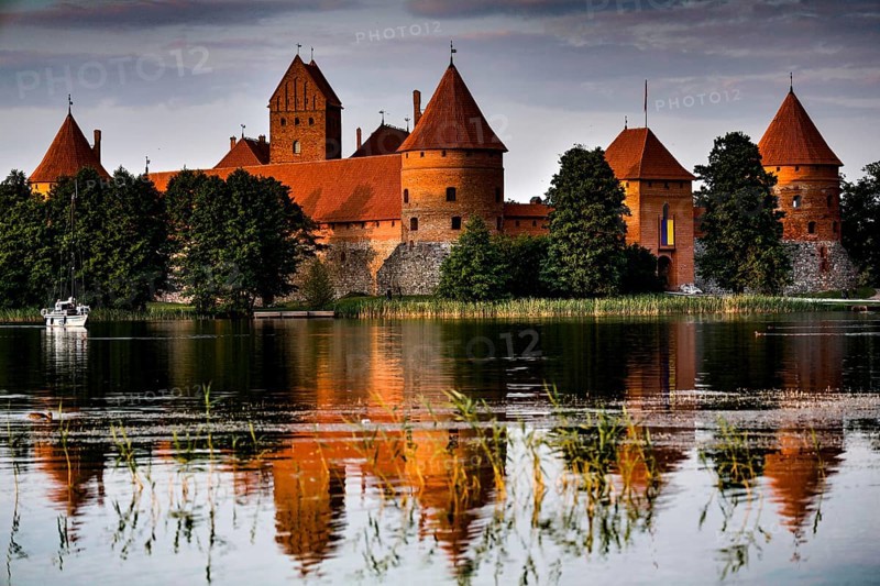 The medieval Trakai Castle is reflected in the calm water of the lake, Trakai, Lithuania