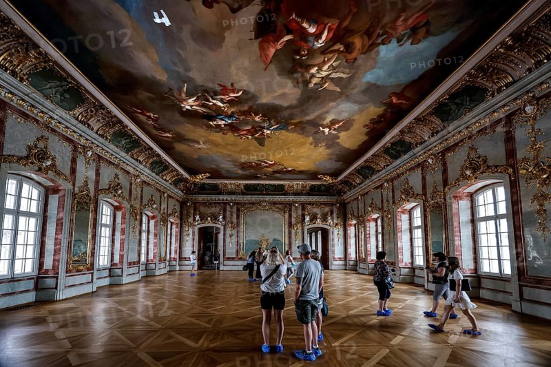 Baroque interior with detailed ceiling painting and visitors, Rundale, Latvia