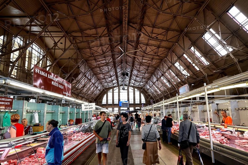 Interior view of bustling central market with historic structures, Riga, Latvia