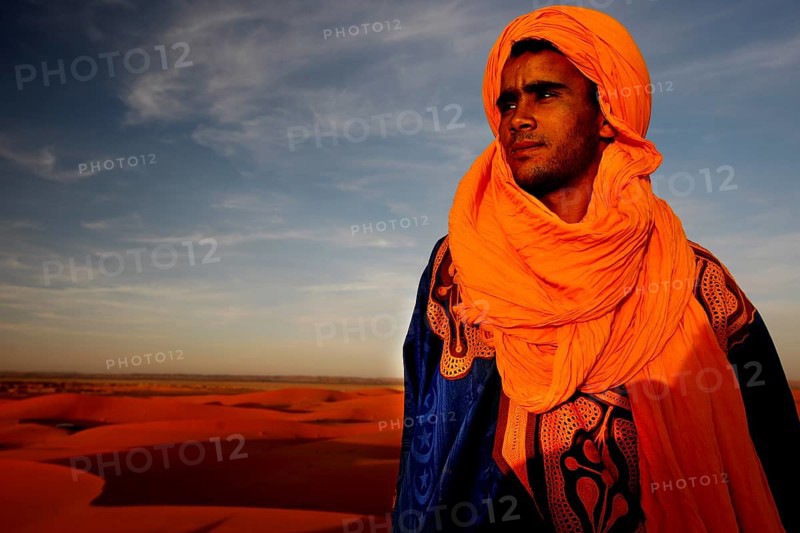 Bedouins in traditional clothing in front of the dunes of Erg Chebbi, Erg Chebbi, Morocco