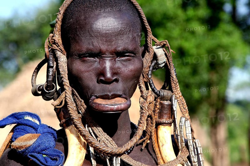 Mursi woman with a large lip plate and traditional clothes in Mago National Park, Mago National Park, Ethiopia