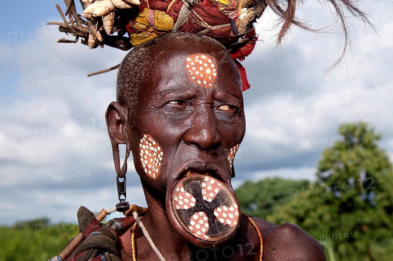 Mursi woman with lip plate and artistic face painting, Mago National Park, Ethiopia