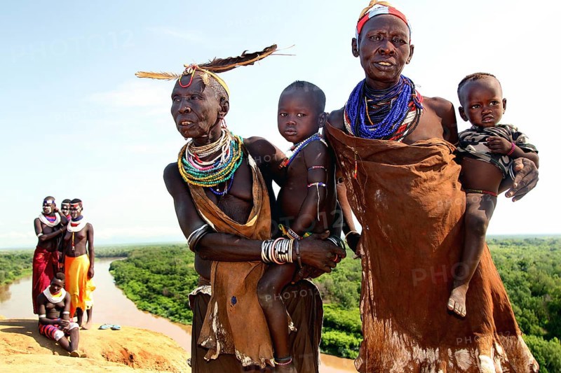 Two woman from Murle with babies and ornate necklaces, Murle, Ethiopia