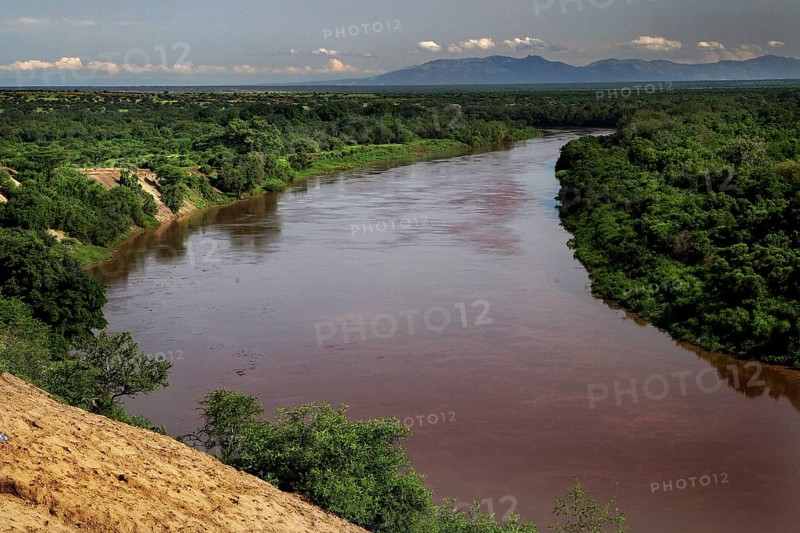 Wide Omo River amid green landscape with views of surrounding hills, Kara Korcno, region, Ethiopia