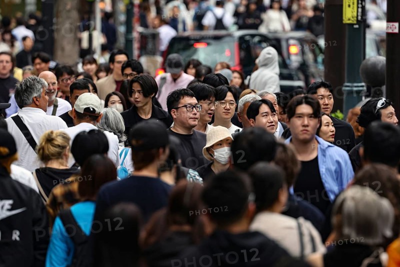 Crowded street scene with many passers-by on Dogen-zaka Street, Tokyo, Japan