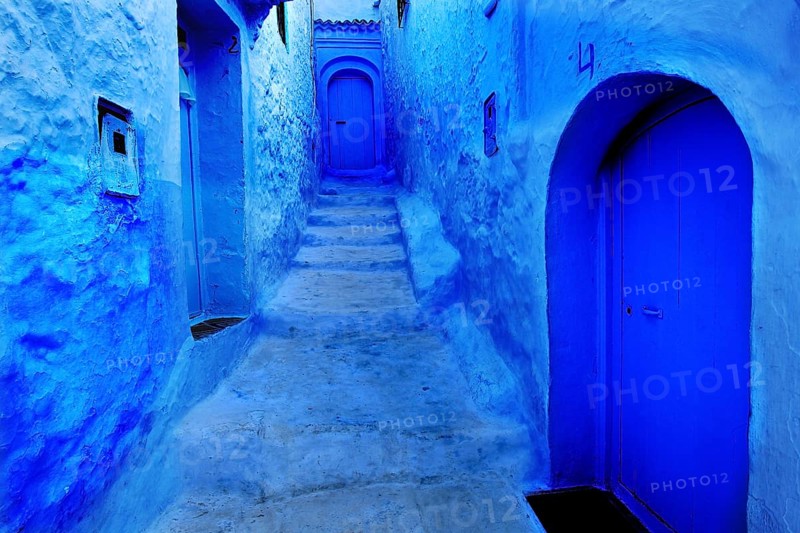 Narrow, blue alleyway section of the medina of Chefchaouen with weathered stairs, Chefchaouen, Tanger-Tetouan, Morocco