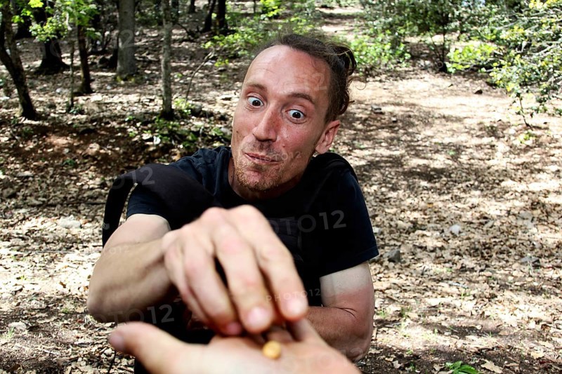 Man feeding with a hand smile in the forest, Azrou, Forèt des Cèdres, Morocco
