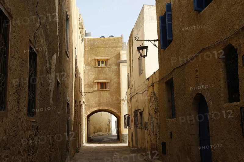 Shady alley with stone buildings and arched passageway, El Jadida, Cité Portugaise, Morocco